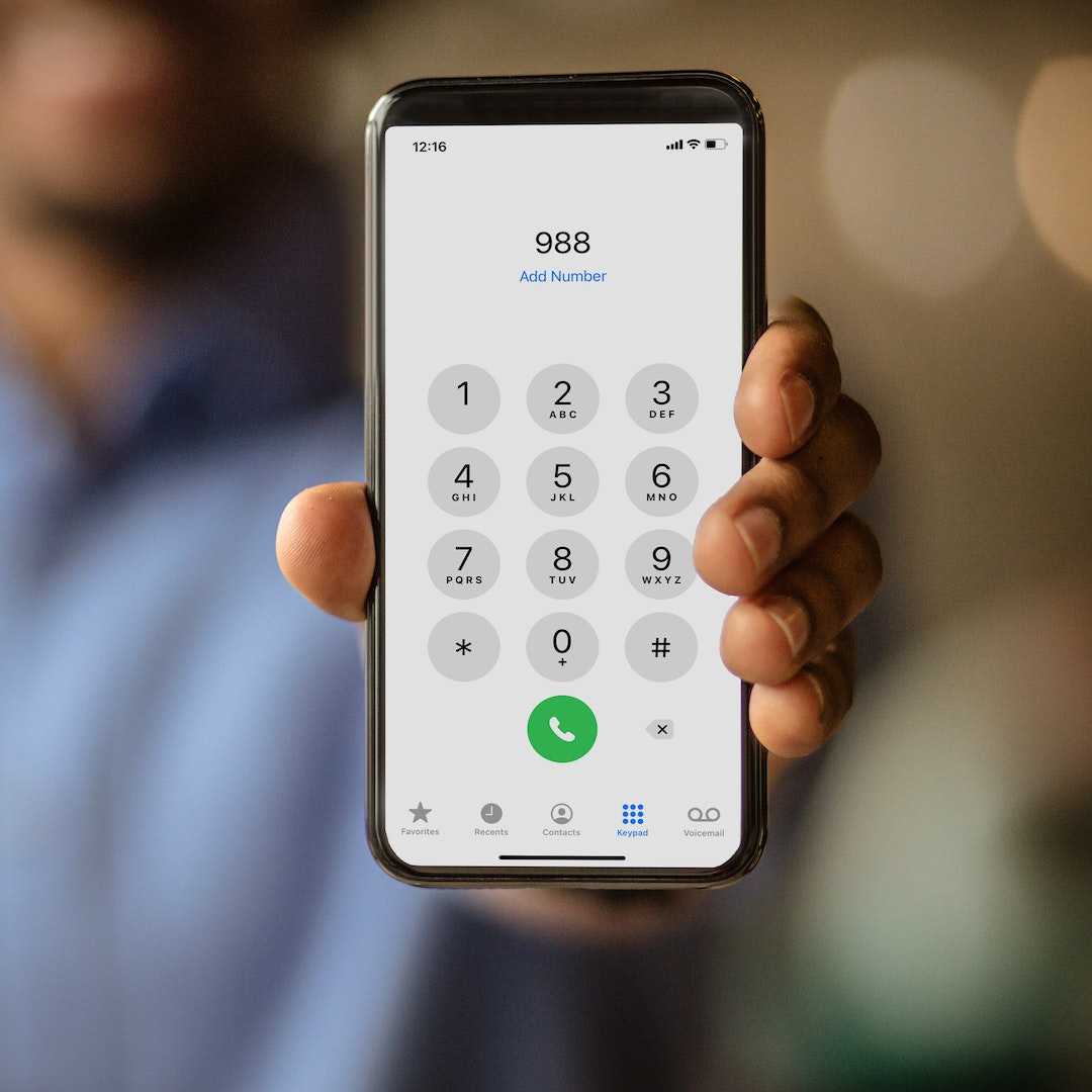 Person holding a phone displaying 988